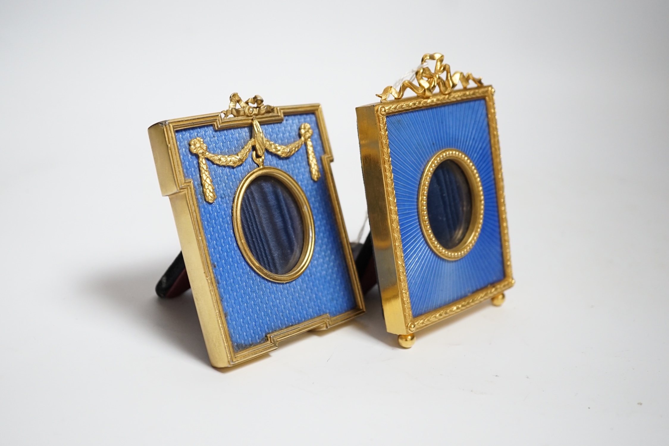 Two gilt metal and enamel miniature frames with fitted cases, largest 11cm high